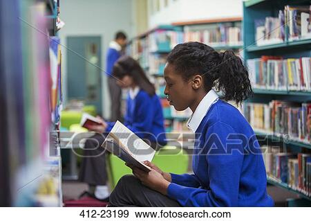 High School students sitting and reading book in library View Large Photo Image Stock Photo - High School students sitting and reading book in library. Fotosearch