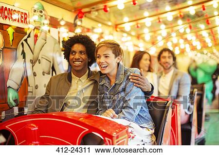 Man embracing girlfriend on ghost train View Large Photo Image Stock Image - Man embracing girlfriend on ghost train. Fotosearch