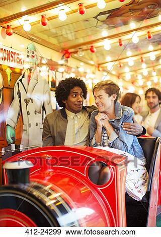 Man embracing scared girlfriend on ghost train View Large Photo Image Stock Photo - Man embracing scared girlfriend on ghost train. Fotosearch