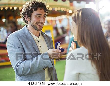 Man proposing to girlfriend in amusement park View Large Photo Image Stock Image - Man proposing to girlfriend in amusement park. Fotosearch