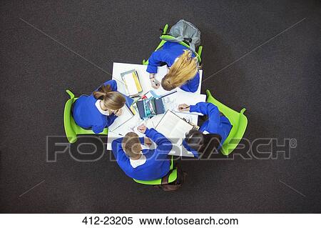 Stock Photography - Overhead view of students doing their homework together. Fotosearch