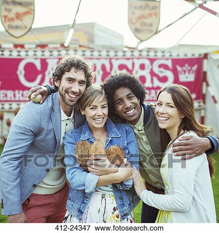 Portrait of four friends having fun in amusement park View Large Photo Image Stock Photo - Portrait of four friends having fun in amusement park. Fotosearch