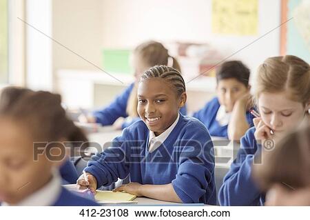 Stock Photo - Portrait of schoolboy learning in classroom. Fotosearch