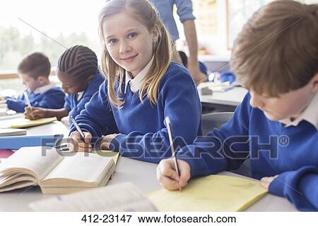 Portrait of smiling girl learning in classroom View Large Photo Image Stock Photo - Portrait of smiling girl learning in classroom. Fotosearch