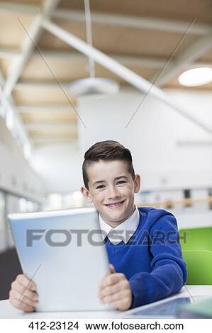 Portrait of smiling schoolboy with tablet pc View Large Photo Image Picture - Portrait of smiling schoolboy with tablet pc. Fotosearch