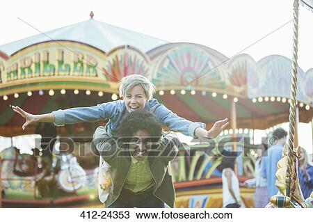 Portrait of young multiracial couple having fun in amusement park View Large Photo Image Stock Image - Portrait of young multiracial couple having fun in amusement park. Fotosearch