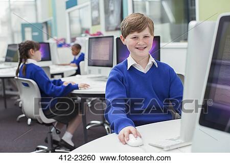 Primary school children working with computers View Large Photo Image Stock Image - Primary school children working with computers. Fotosearch