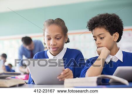 Pupils using tablet pc's in classroom View Large Photo Image Stock Photo - Pupils using tablet pc's in classroom. Fotosearch