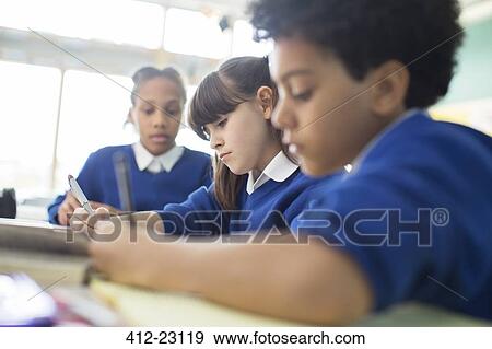 Schoolboys and schoolgirls learning in classroom View Large Photo Image Stock Photo - Schoolboys and schoolgirls learning in classroom. Fotosearch