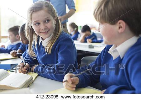 Schoolgirl and schoolboy learning in classroom View Large Photo Image Stock Photography - Schoolgirl and schoolboy learning in classroom. Fotosearch