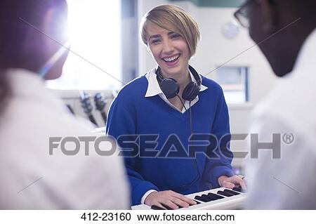 Smiling students playing synthesizer in classroom View Large Photo Image Stock Image - Smiling students playing synthesizer in classroom. Fotosearch