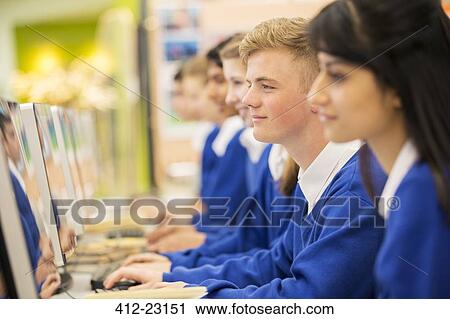 Smiling students using computers in computer room View Large Photo Image Stock Image - Smiling students using computers in computer room. Fotosearch