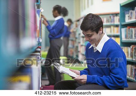Student reading book in library View Large Photo Image Stock Photography - Student reading book in library. Fotosearch