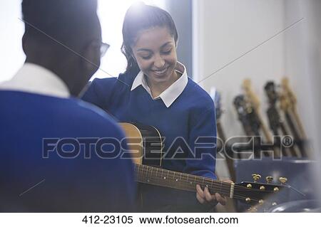Students playing acoustic guitar in classroom View Large Photo Image Stock Photography - Students playing acoustic guitar in classroom. Fotosearch