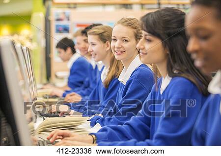 Stock Photograph - Students sitting in row during IT lesson. Fotosearch