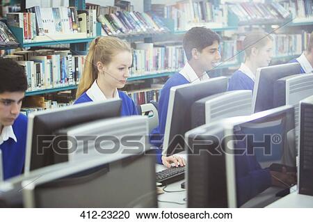 Students working on computers in library View Large Photo Image Stock Image - Students working on computers in library. Fotosearch