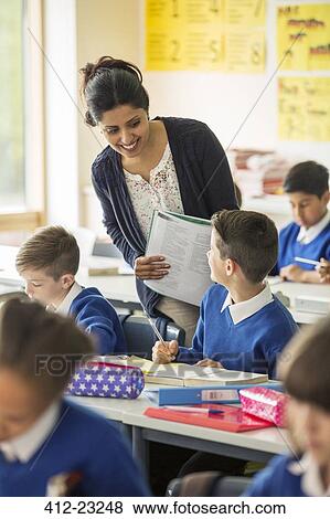 Teacher and elementary school children in classroom during lesson View Large Photo Image Stock Photo - Teacher and elementary school children in classroom during lesson. Fotosearch