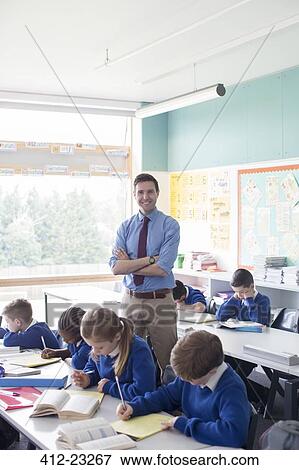 Stock Photo - Teacher and primary school children in classroom during lesson. Fotosearch