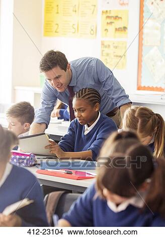 Teacher with his pupils in classroom View Large Photo Image Picture - Teacher with his pupils in classroom. Fotosearch
