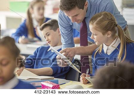 Teacher with his pupils in classroom using tablet pc View Large Photo Image Stock Image - Teacher with his pupils in classroom using tablet pc. Fotosearch