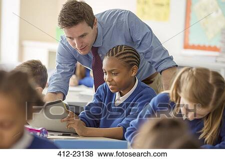 Teacher with his pupils in classroom View Large Photo Image Stock Photo - Teacher with his pupils in classroom. Fotosearch