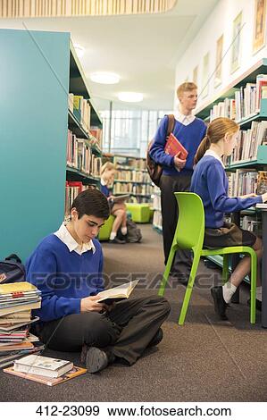 Teenage students learning in college library View Large Photo Image Stock Photo - Teenage students learning in college library. Fotosearch