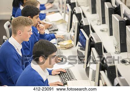 Teenage students using computers in computer room View Large Photo Image Stock Image - Teenage students using computers in computer room. Fotosearch