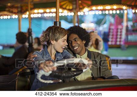 Young couple on bumper car ride in amusement park View Large Photo Image Picture - Young couple on bumper car ride in amusement park. Fotosearch