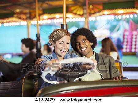 Young couple on bumper car ride in amusement park View Large Photo Image Stock Image - Young couple on bumper car ride in amusement park. Fotosearch