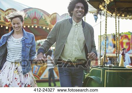 Young multiracial couple having fun in amusement park View Large Photo Image Stock Photo - Young multiracial couple having fun in amusement park. Fotosearch