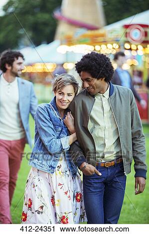 Young multiracial couple smiling in amusement park View Large Photo Image Stock Image - Young multiracial couple smiling in amusement park. Fotosearch