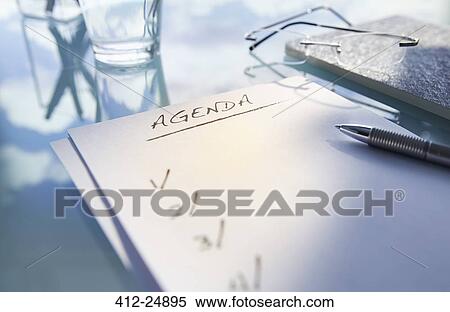 "Close up of desk with, glass, glasses and note saying 'agenda', pen" View Large Photo Image Stock Photography - "Close up of desk with, glass, glasses and note saying 'agenda', pen". Fotosearch