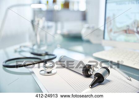 Stock Image - "Desk with speculum, stethoscope and computer". Fotosearch