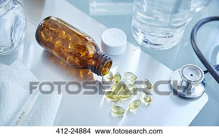 Picture - Flask with capsules and stethoscope on desk. Fotosearch