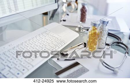 Stock Photography - "Flasks with pills, stethoscope and keycard, View of desk with computer". Fotosearch