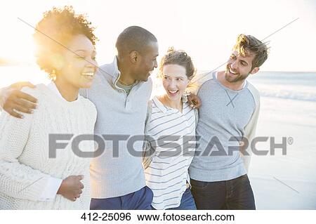 Group of cheerful friends on beach View Large Photo Image Stock Photograph - Group of cheerful friends on beach. Fotosearch