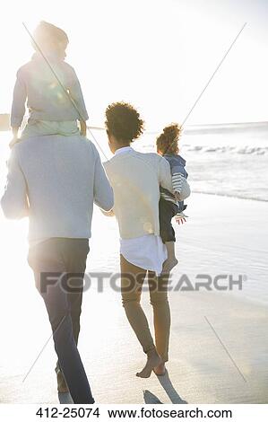 Happy family having fun on beach View Large Photo Image Picture - Happy family having fun on beach. Fotosearch