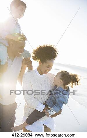Happy family having fun on beach View Large Photo Image Picture - Happy family having fun on beach. Fotosearch