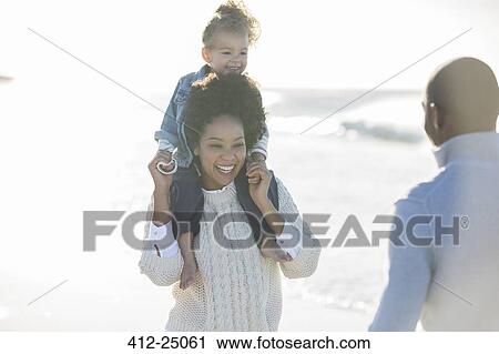 Happy family having fun on beach View Large Photo Image Stock Image - Happy family having fun on beach. Fotosearch