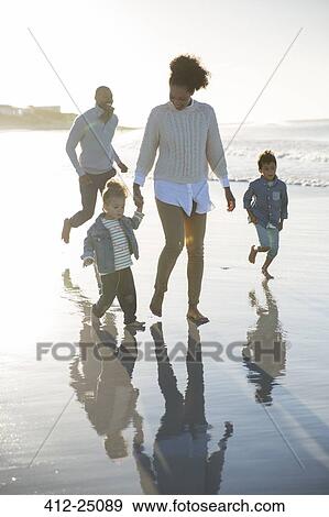 Happy family having fun on beach View Large Photo Image Stock Photo - Happy family having fun on beach. Fotosearch