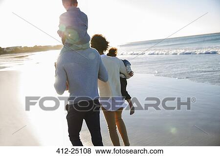 Happy family walking on beach View Large Photo Image Stock Photo - Happy family walking on beach. Fotosearch