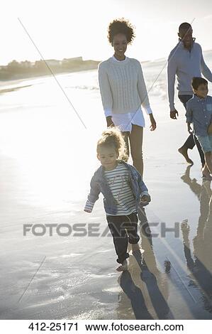 Happy walking on beach at sunset View Large Photo Image Stock Image - Happy walking on beach at sunset. Fotosearch