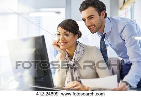 Man and woman working together in office View Large Photo Image Stock Photo - Man and woman working together in office. Fotosearch
