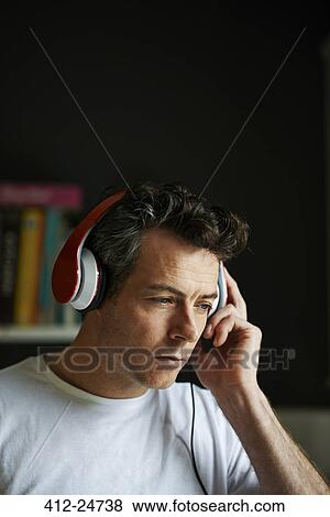 Man with headphones on listening View Large Photo Image Stock Photo - Man with headphones on listening. Fotosearch