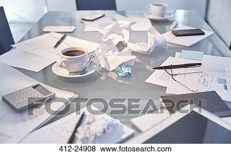 Messy table in conference room of modern office View Large Photo Image Stock Photo - Messy table in conference room of modern office. Fotosearch