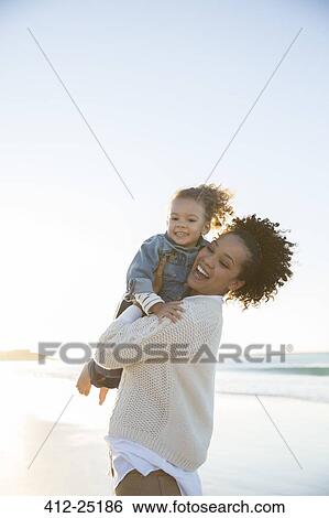 Mother and daughter embracing on beach View Large Photo Image Stock Photograph - Mother and daughter embracing on beach. Fotosearch