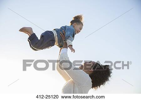 Mother and daughter playing on beach View Large Photo Image Stock Image - Mother and daughter playing on beach. Fotosearch