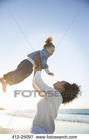 Mother and daughter playing on beach View Large Photo Image Stock Photo - Mother and daughter playing on beach. Fotosearch