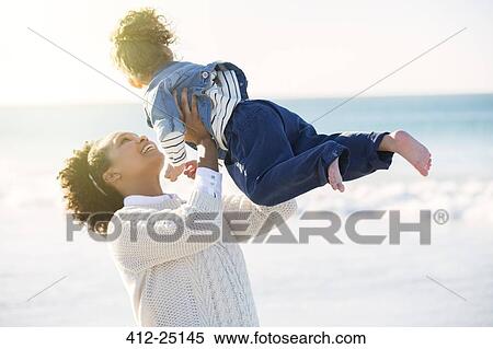 Mother and daughter playing on beach View Large Photo Image Stock Photography - Mother and daughter playing on beach. Fotosearch