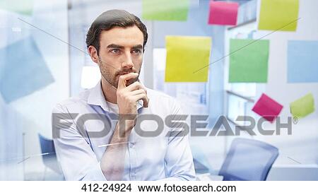 Office worker behind glass with colorful sticky notes thinking View Large Photo Image Picture - Office worker behind glass with colorful sticky notes thinking. Fotosearch